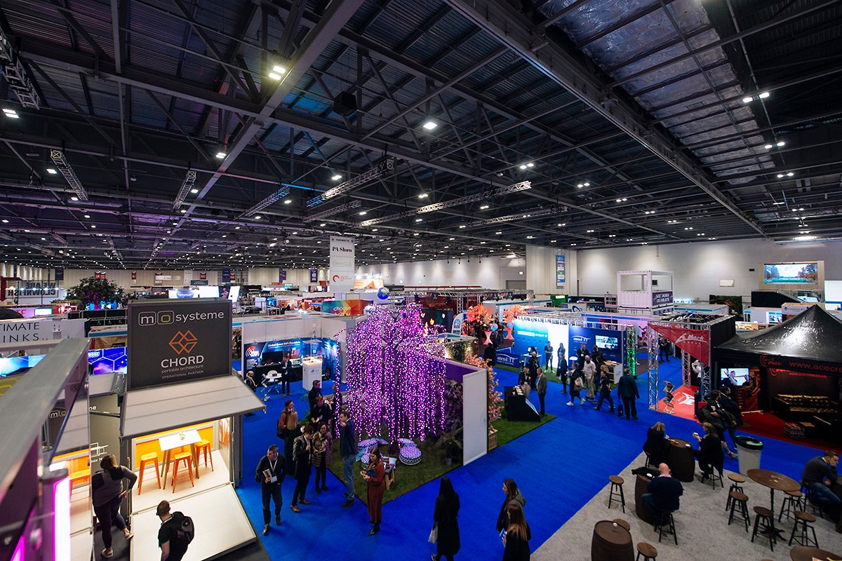 View of International Confex with exhibition stands and attendees networking across the floor